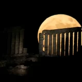 The strawberry full moon rises behind the ancient temple of Poseidon at Cape Sounion, about 70 kilometers (45 miles) south of Athens, Greece. (June 14, 2022)