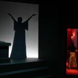 An employe opens a door as the silhouette of Greek Soprano Maria Callas is shown on screen, at the newly established Museum, the first dedicated to the legendary opera star, in Athens, Greece. (October 25, 2023)