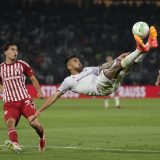 Fiorentina's Nicolas Gonzalez, right, jumps kicking the ball past Olympiacos' Santiago Hezze during the Conference League final soccer at OPAP Arena in Athens, Greece. (May 30, 2024)